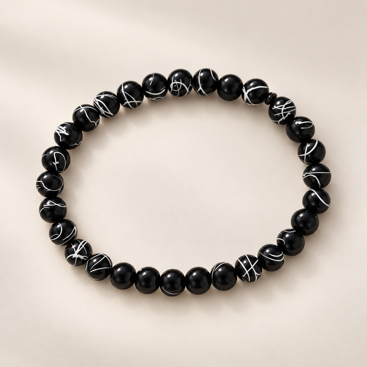 Bracelet noir à perles marbrées blanches