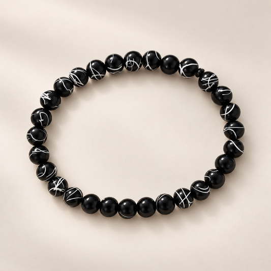 Bracelet noir à perles marbrées blanches